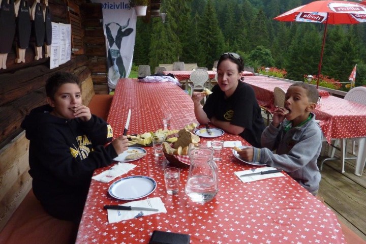 family during lunch on a Swiss farm