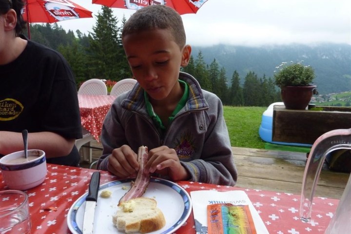 boy eating bacon and bread