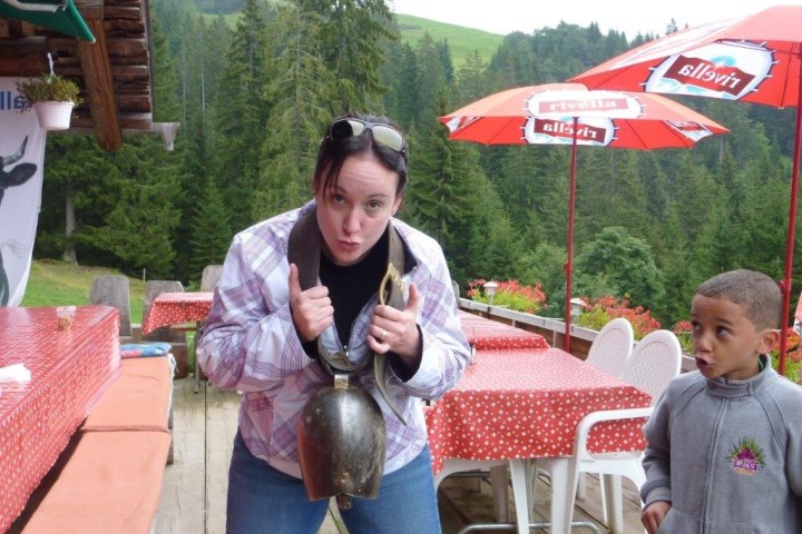 woman with a cow bell around her neck