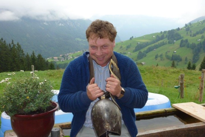 man holding a cow bell