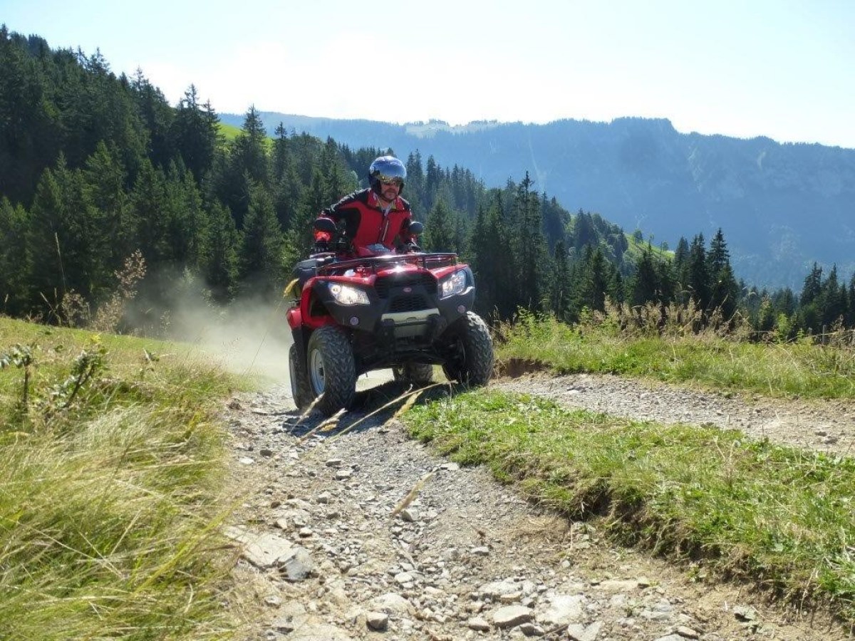 man wearing a red jacket on a red quad