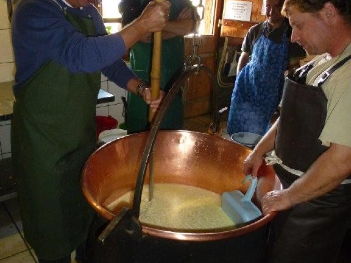 mixing cheese with a wooden stick