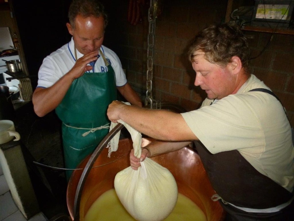 men smelling the ball filled with cheese