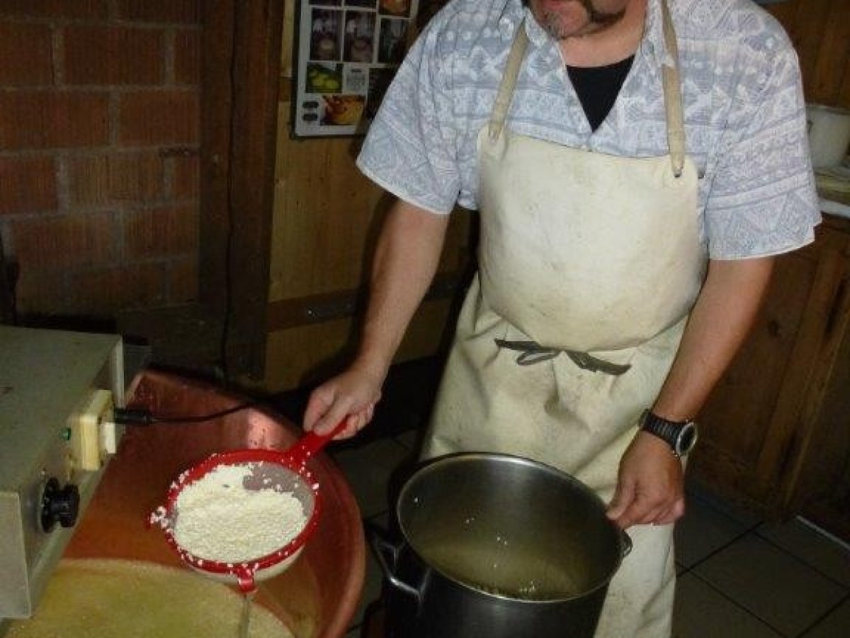 man showing how they make cheese