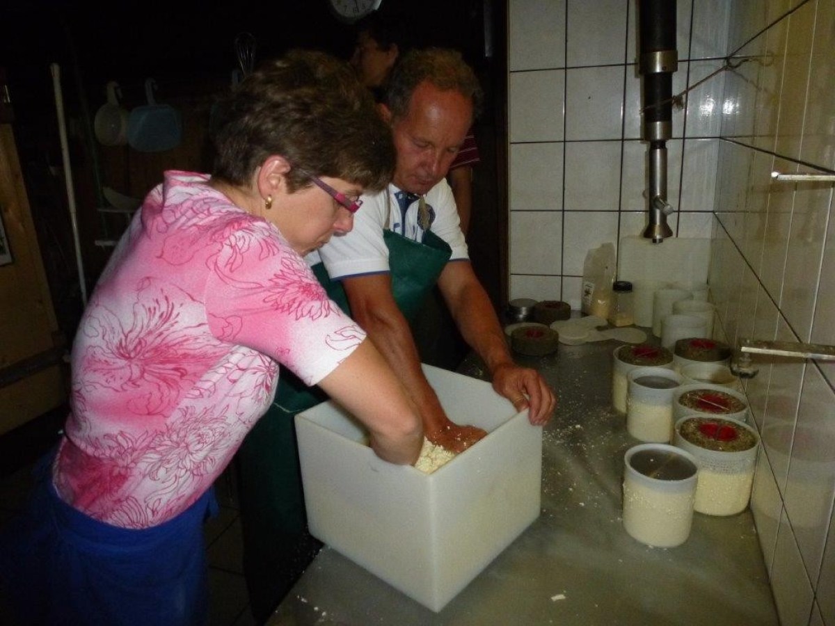 man and woman making cheese