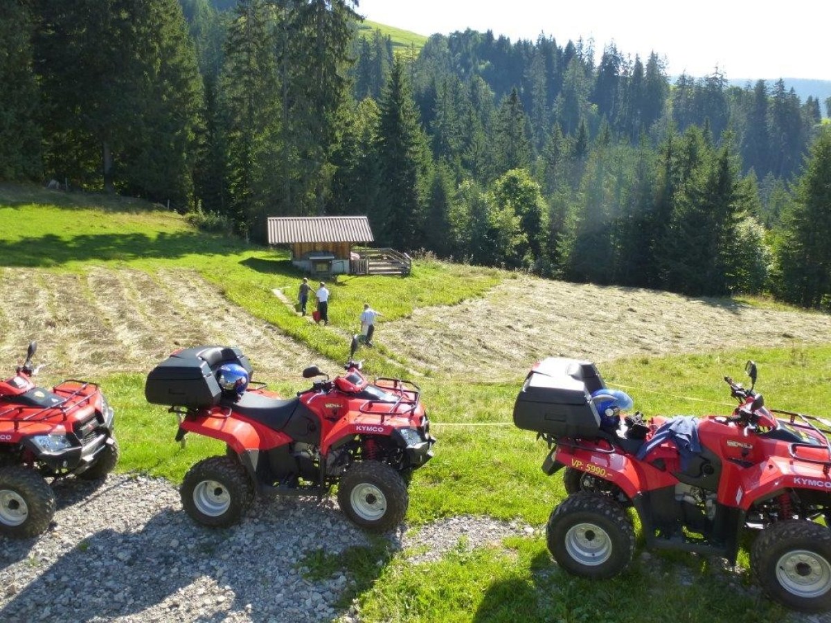 red quads parked near a cottage
