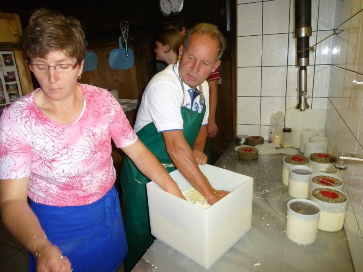 man and woman making cheese