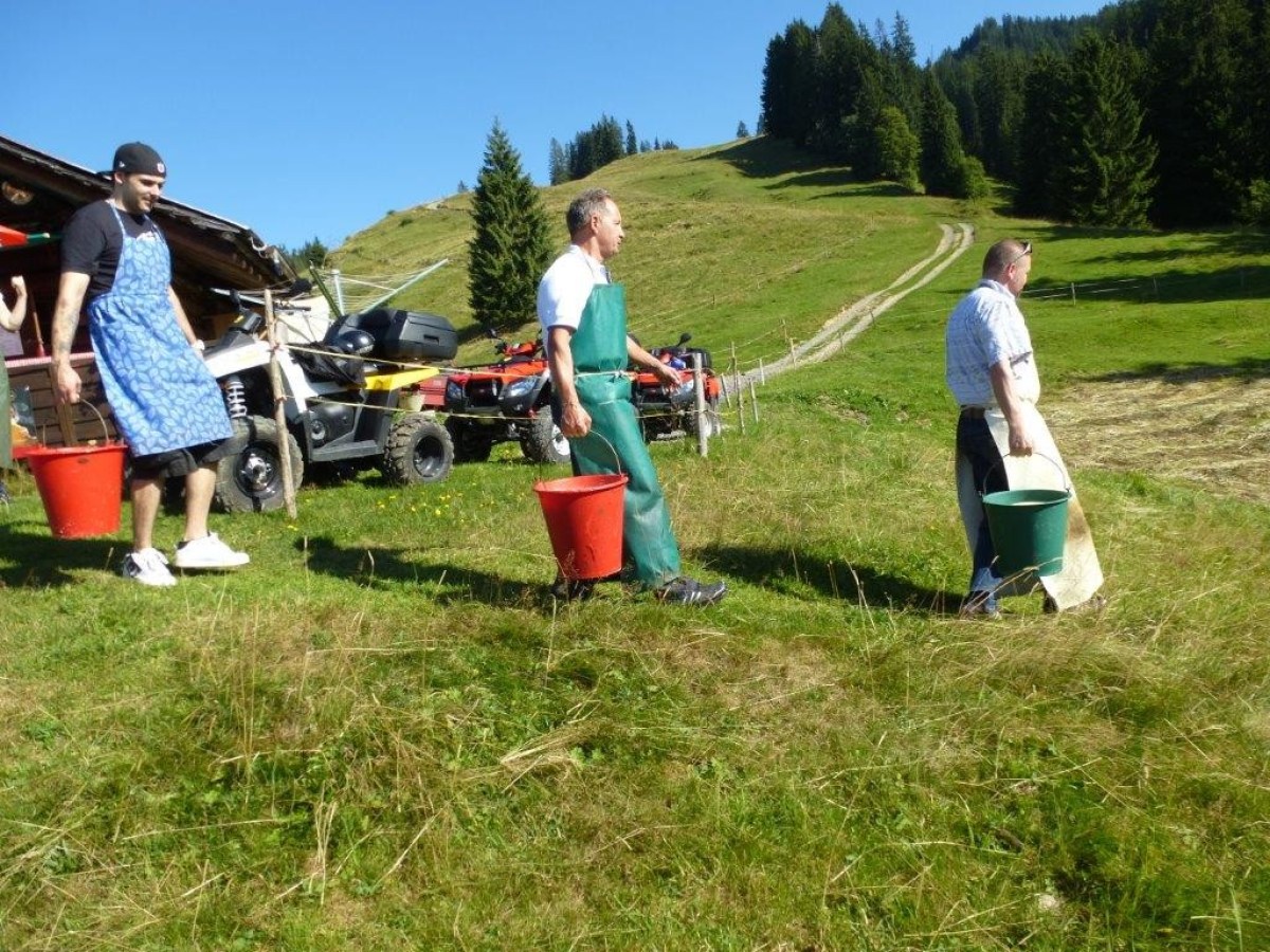 men walking with buckets in their hands