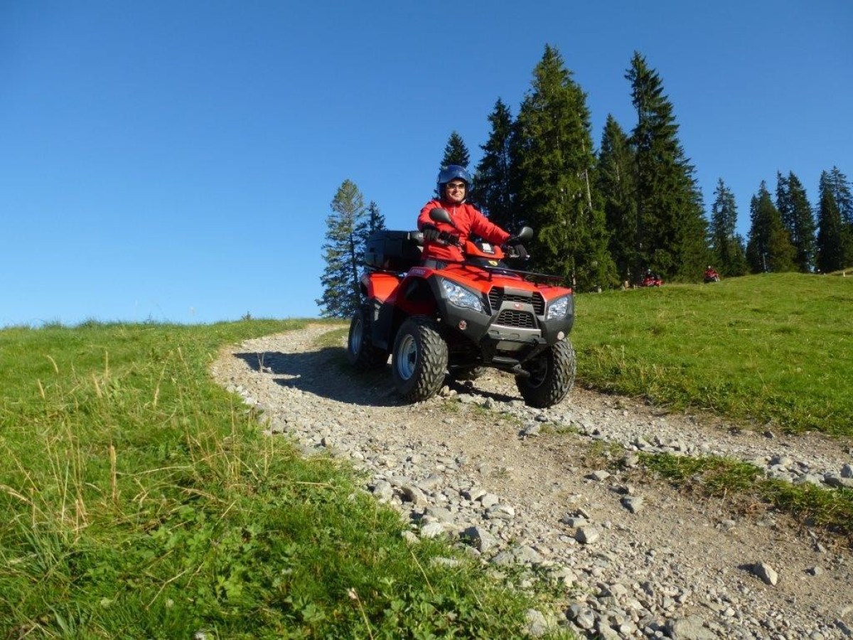 riding a red quad with a helmet