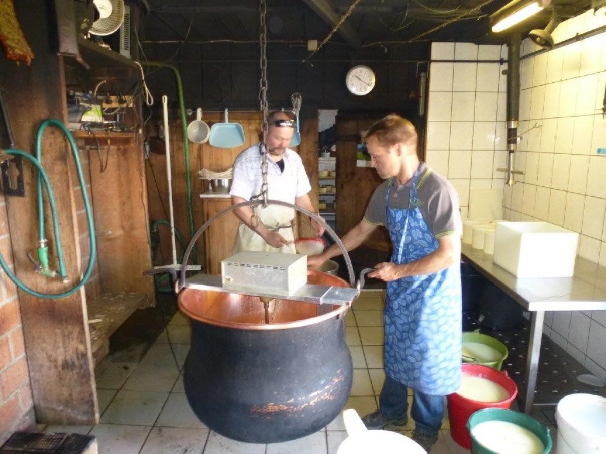 2 men during a cheese making process
