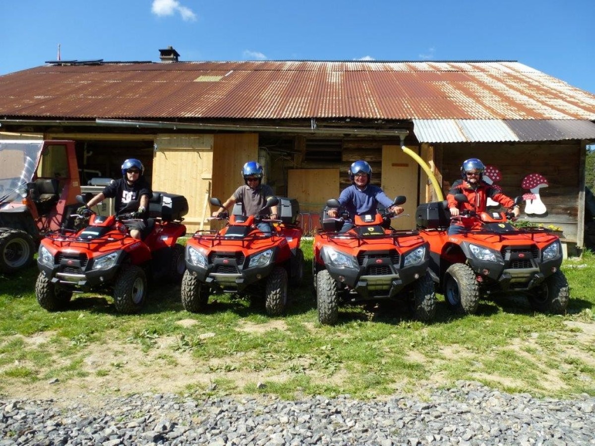 4 men wearing helmets on a quad