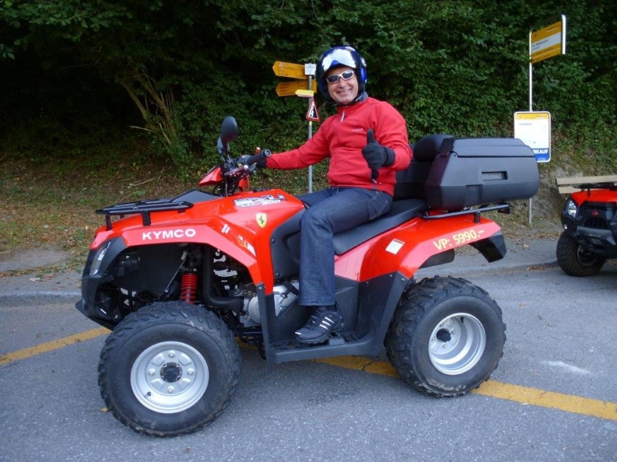 man with a red jumper on a red quad