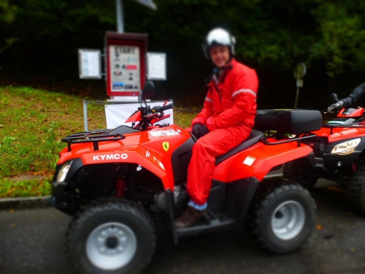 man with a red jumpsuit on a red quad