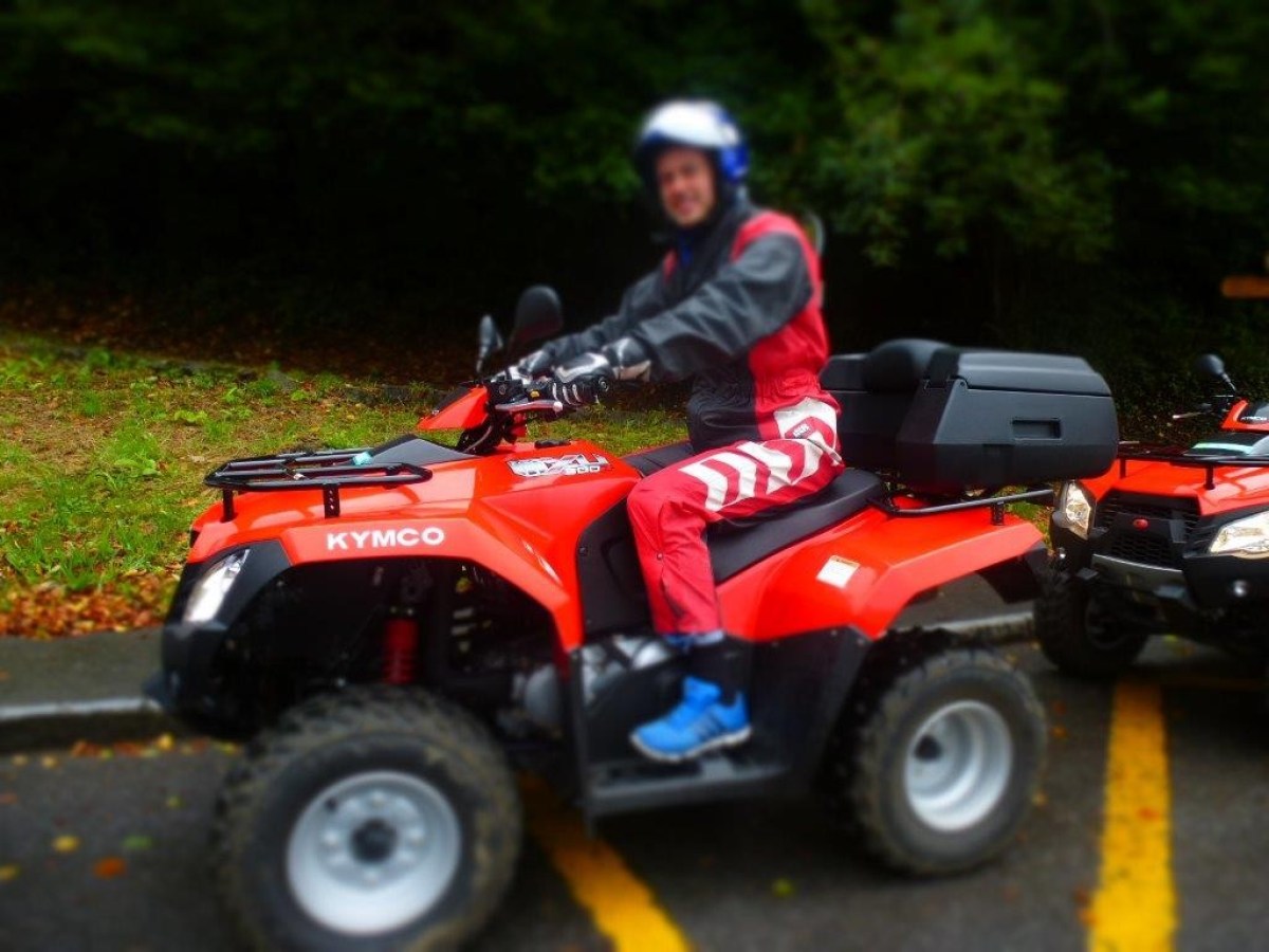 man with a red jumpsuit on a red quad