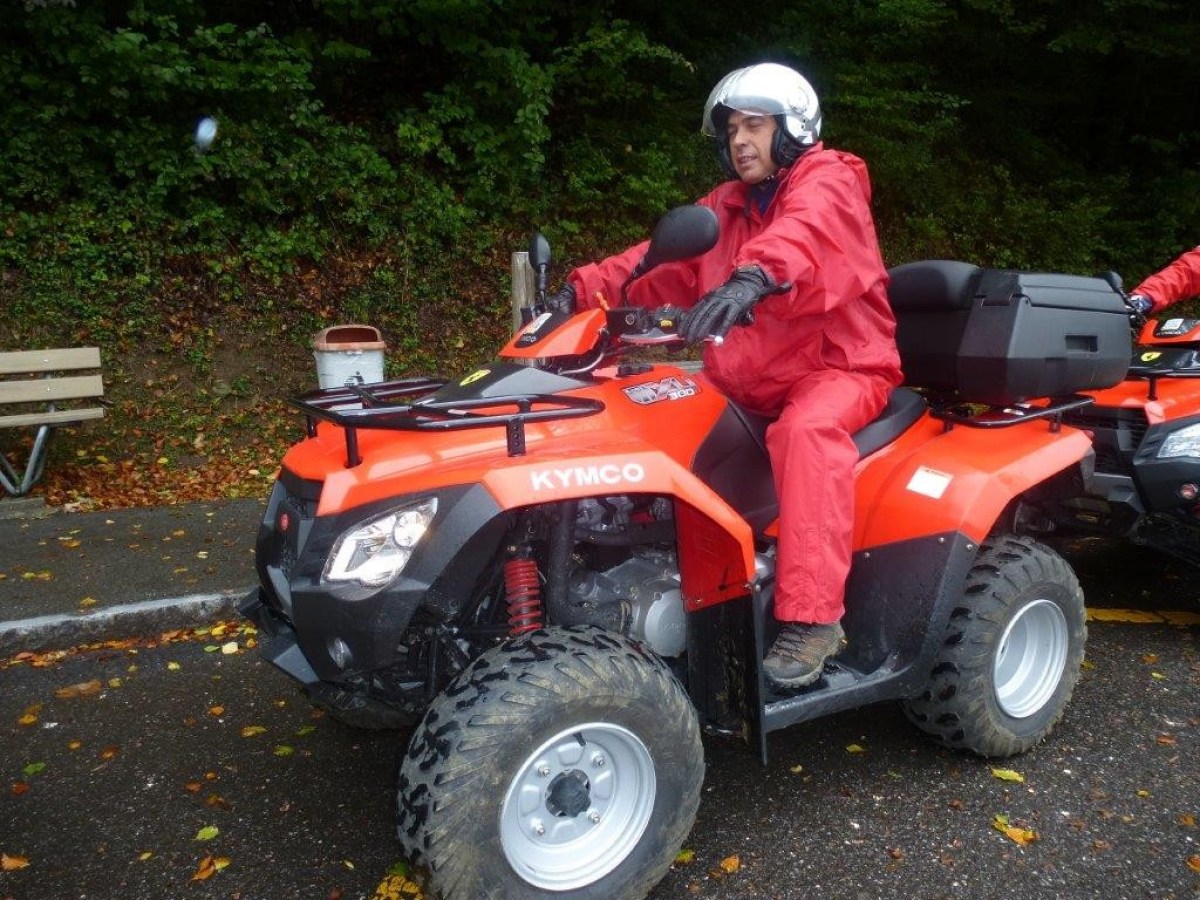 man with a red jumpsuit on a red quad