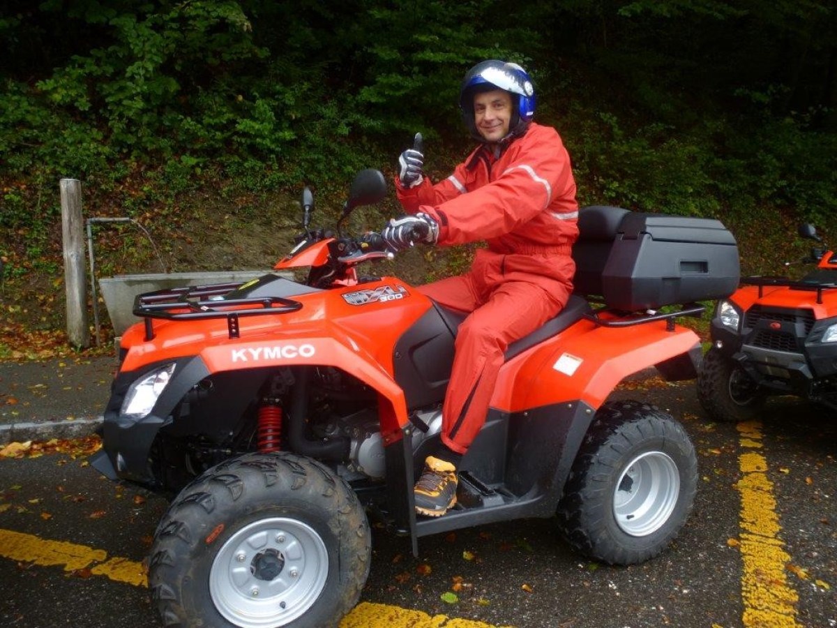 man with a red jumpsuit on a red quad