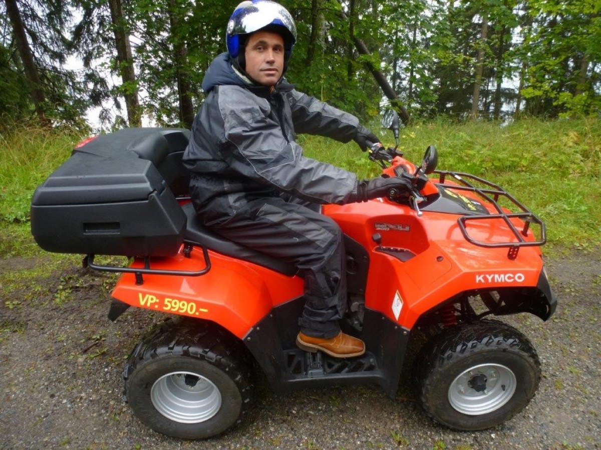 man with a black jumpsuit on a red quad
