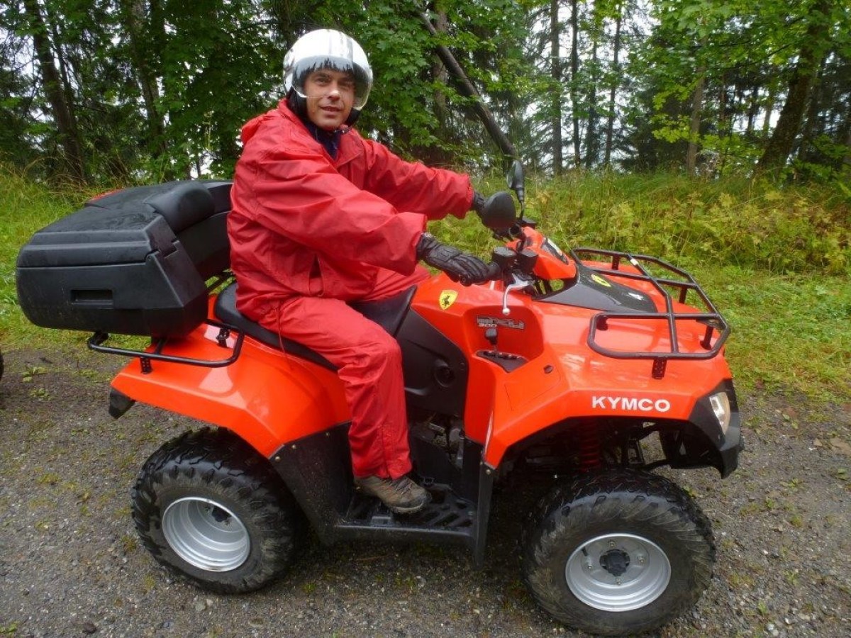 man with a red jumpsuit on a red quad