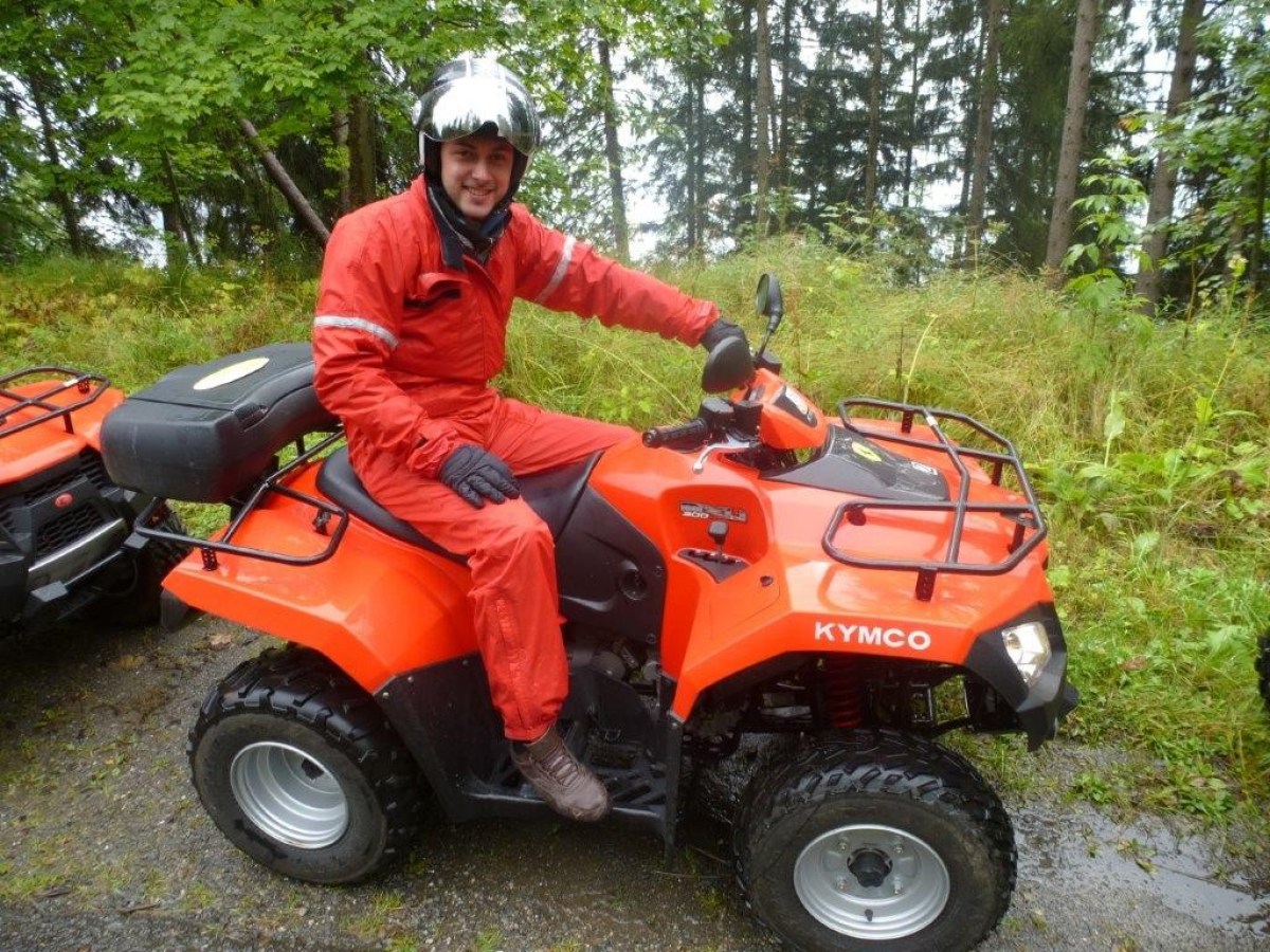 man with a red jumpsuit on a red quad