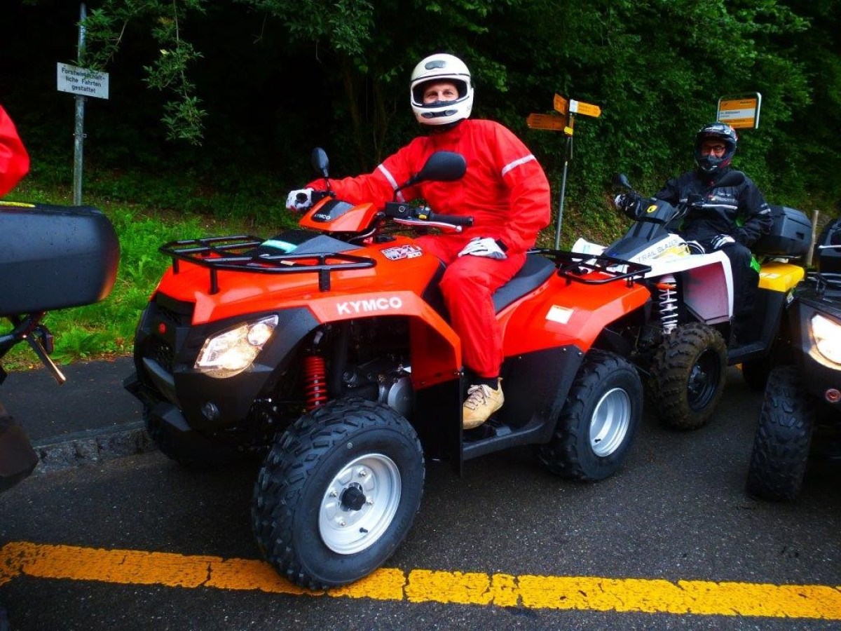 man with a red jumpsuit on a red quad