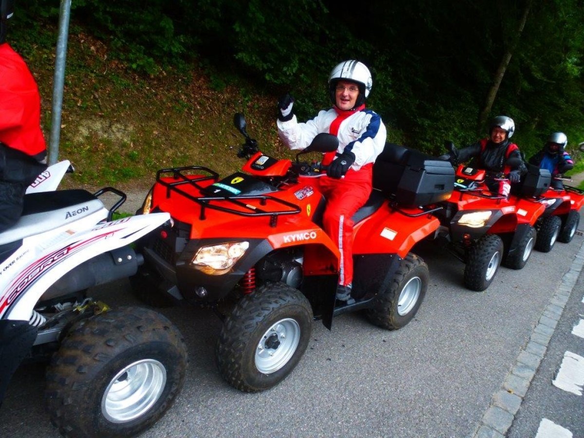 man with a white helmet on a red quad
