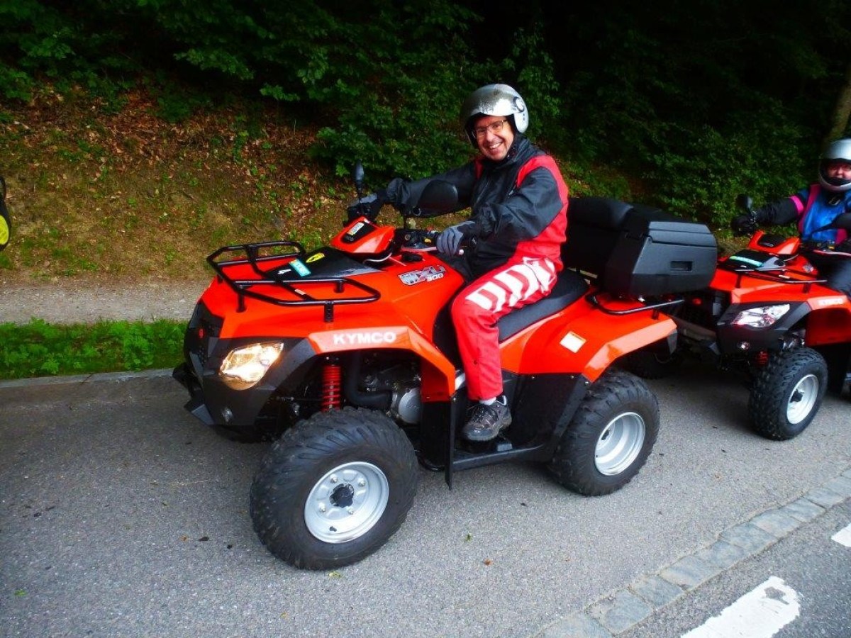 man posing for the picture on a red quad