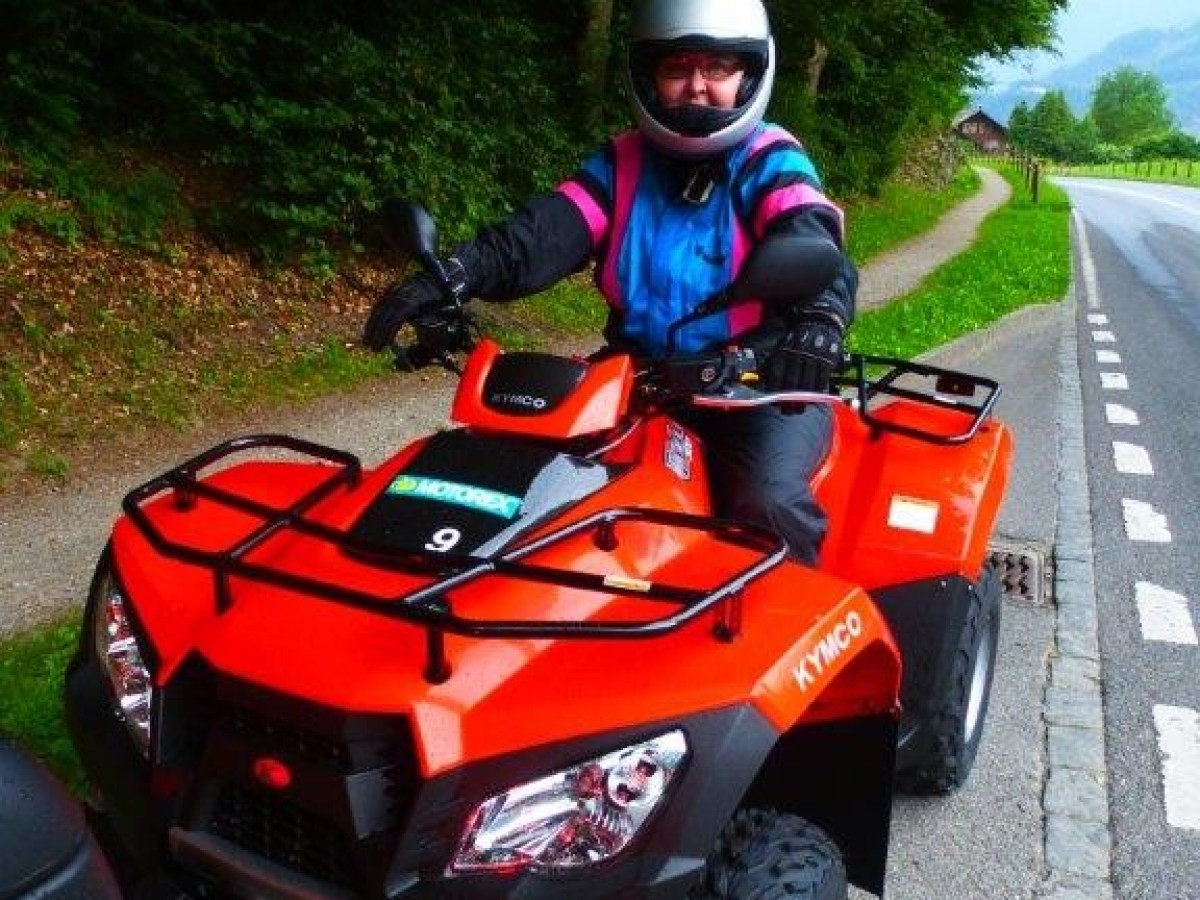 woman on a red kymco quad