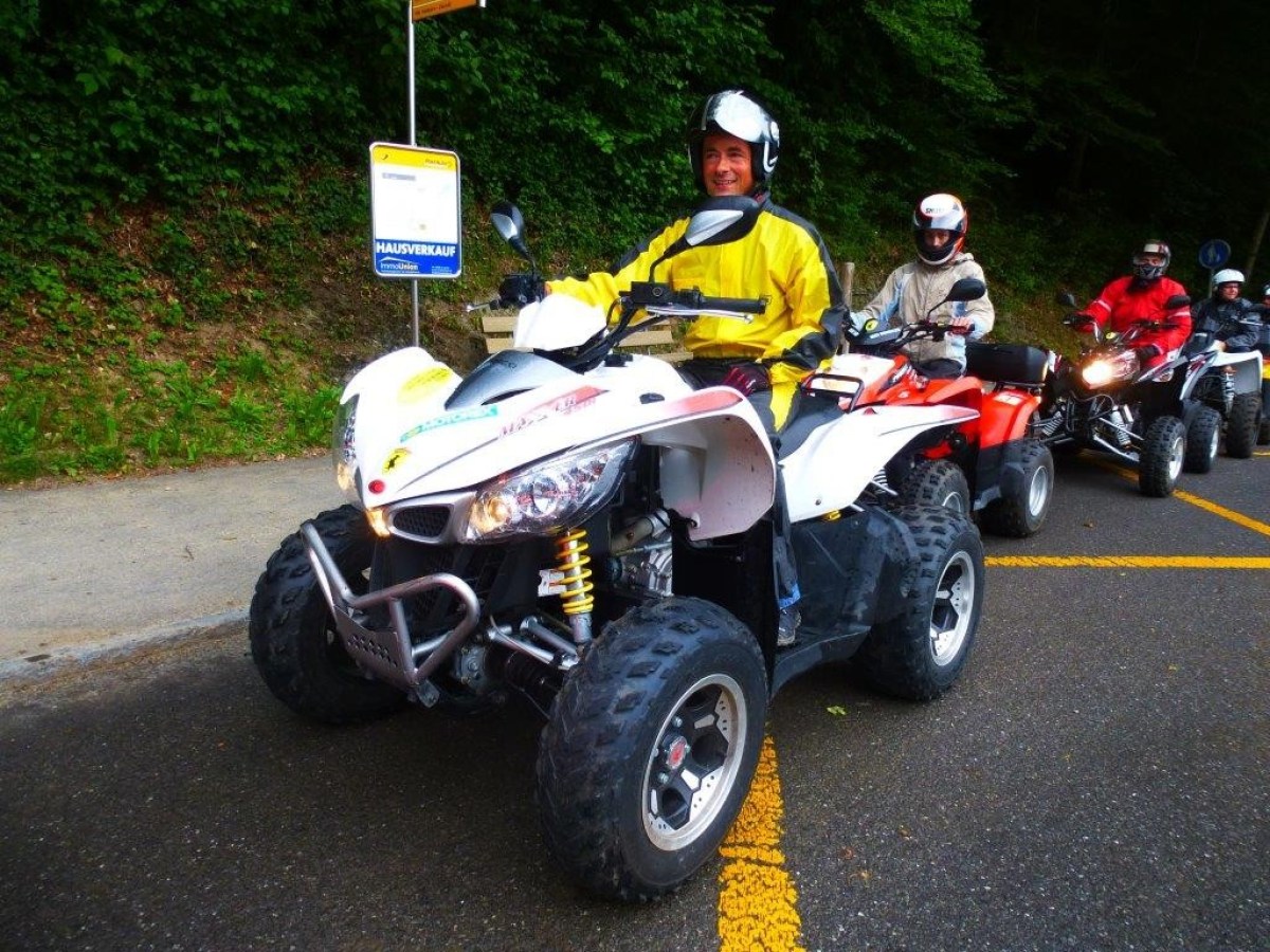 man wearing a yellow jumpsuit on a white quad