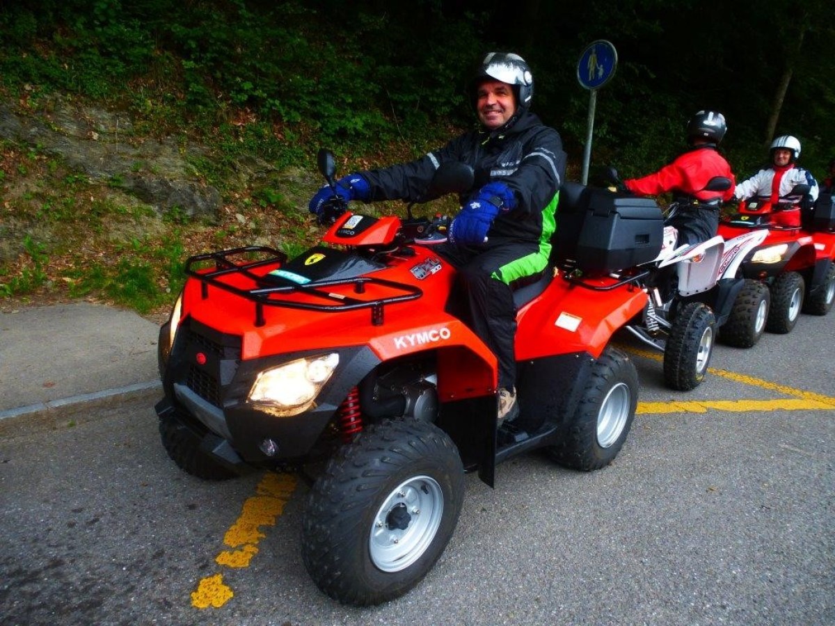 man with a black jumpsuit on a red quad