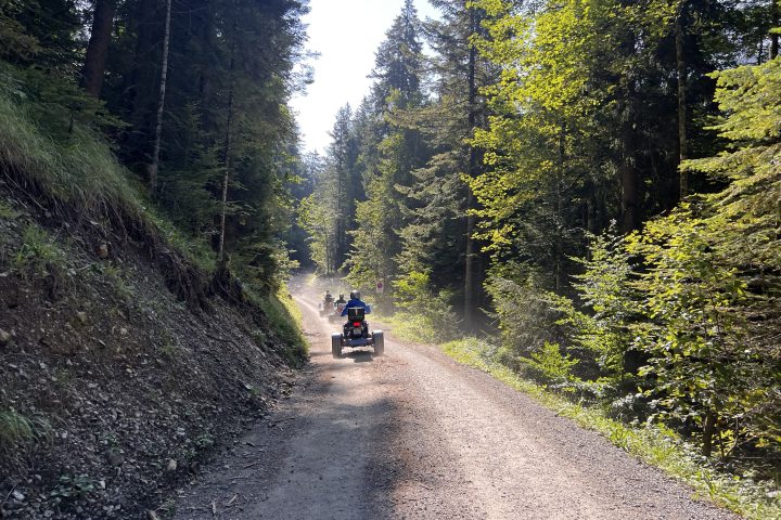 a man riding a motorcycle down a dirt road