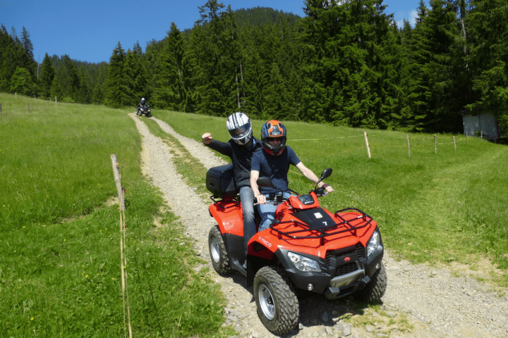 two guys on a quad during a tour