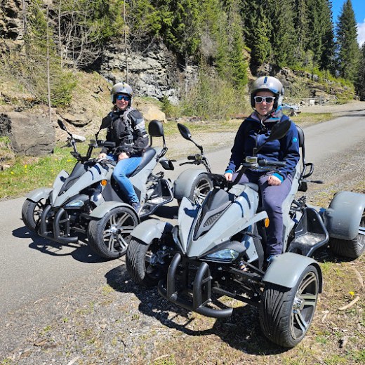 a group of people sitting on a motorcycle