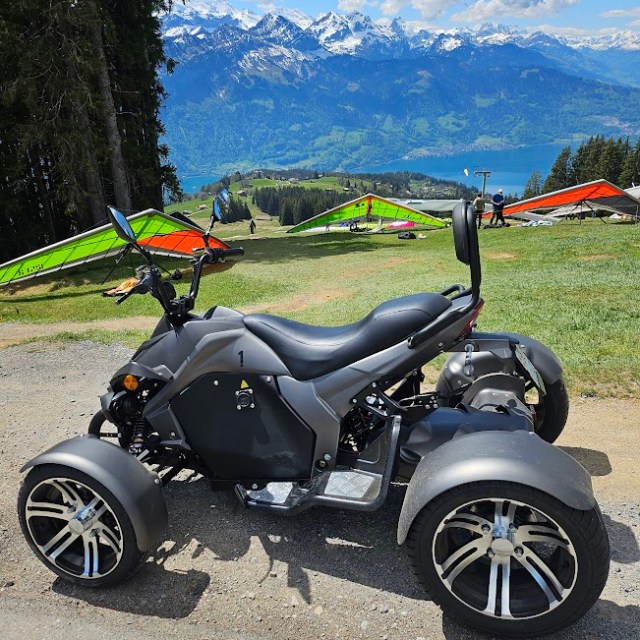 a motorcycle parked on the side of a mountain