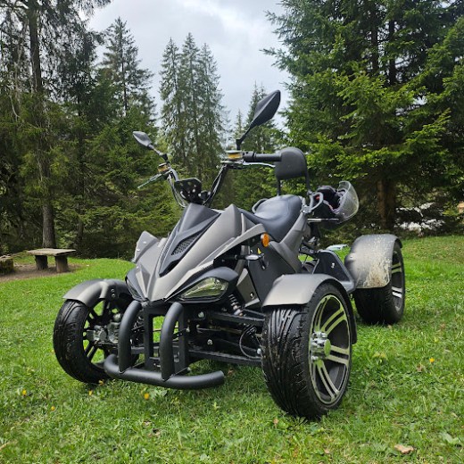 a motorcycle parked on top of a lush green field