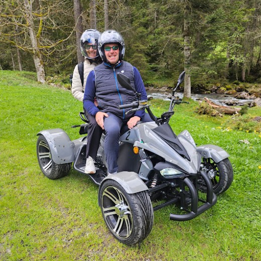 a person sitting on a motorcycle in a field