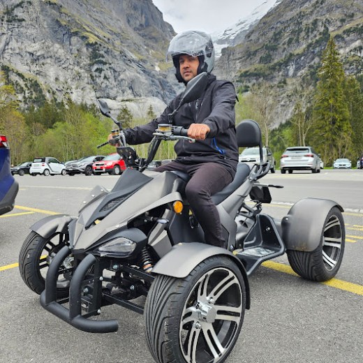 a man riding a motorcycle on the side of a mountain
