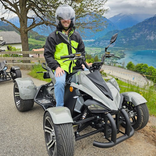 a person riding a motorcycle down a dirt road