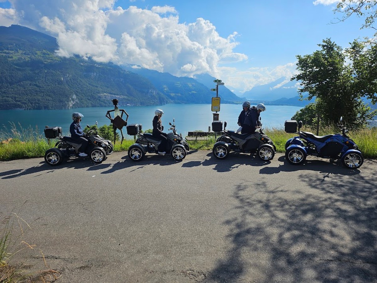 a group of people riding on the back of a motorcycle