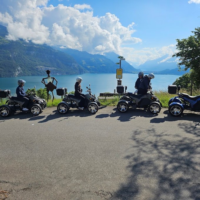 a group of people riding on the back of a motorcycle