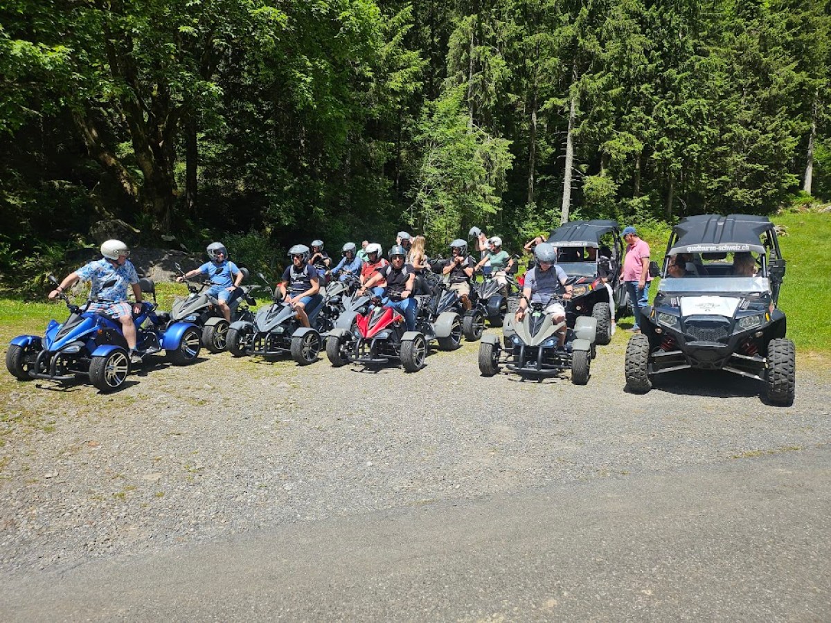 a group of people riding a motorcycle down a dirt road