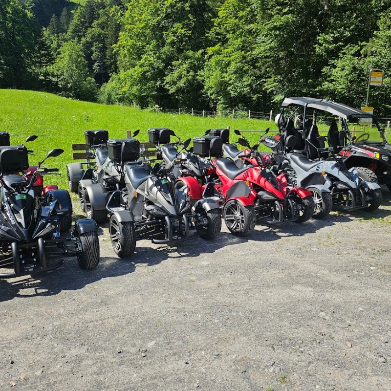 a group of people on a motorcycle parked on the side of a road
