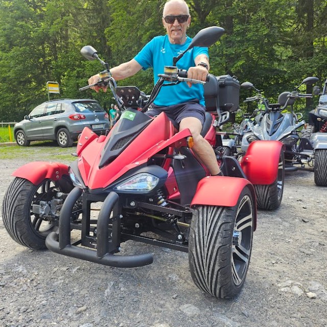 a person riding a motorcycle down a dirt road