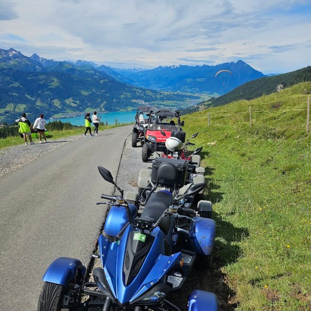 a e atv parked on the side of a mountain